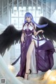 A woman in a purple dress with black wings.