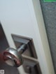 A close up of a door handle on a door.