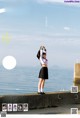 A woman in a school uniform standing on a pier.